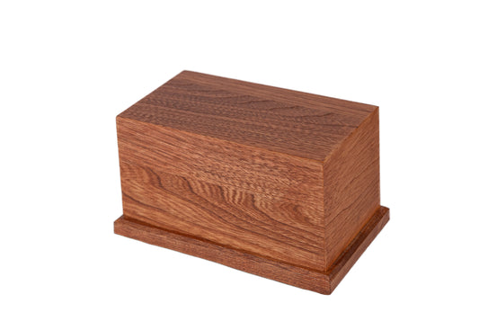 Angled view of 80 cubic inch handcrafted keepsake urn made from 1910 New York piano ash wood, stained Traditional Cherry with satin finish