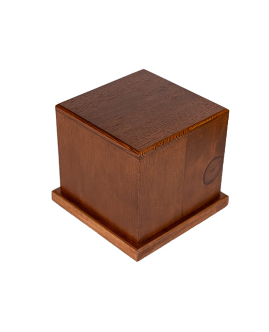 Angled view of 120 cubic inch urn handcrafted from antique Pine and Cuban Mahogany, with satin finish and Antique Walnut brown stained body