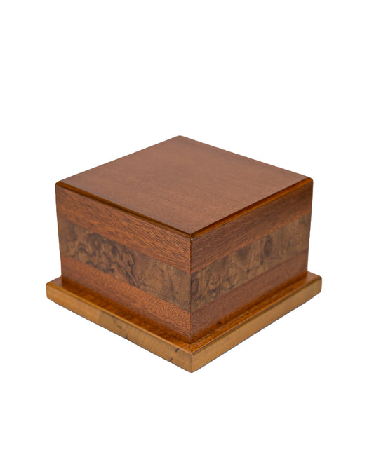 Angled view of handcrafted 62 cubic inch cremation urn made from 1920s Black Walnut, 1885 English Walnut Burl, and Sitka Spruce, finished in Golden Wheat satin