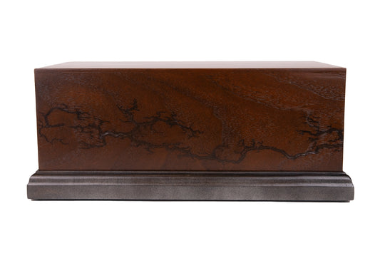 Front view of handcrafted cremation urn made from Black Walnut with electric Lichtenberg wood burns, featuring Honduran Rosewood top and blackened Figured Maple base, 260 cubic inch capacity