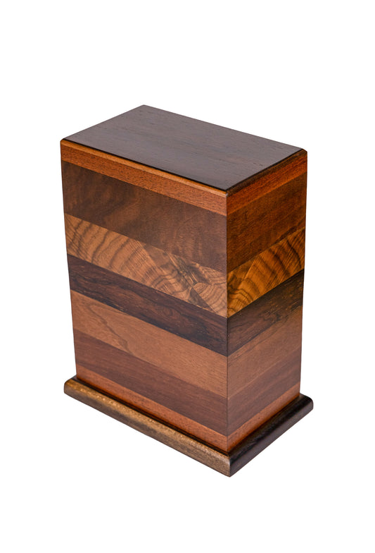 Handcrafted cremation urn featuring nearly 200-year-old Chestnut wood top, English Walnut, English Walnut Burl, American Black Walnut, Brazilian Rosewood, and dark stained American White Ash base, 275 cubic inch capacity, angled view