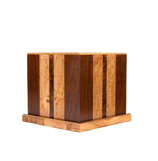 Handcrafted cremation urn made from rare English Walnut Birdseye, Black Walnut, and Walnut Burl with Spruce top, sourced from historic pianos, 175 cubic inch capacity, angled view