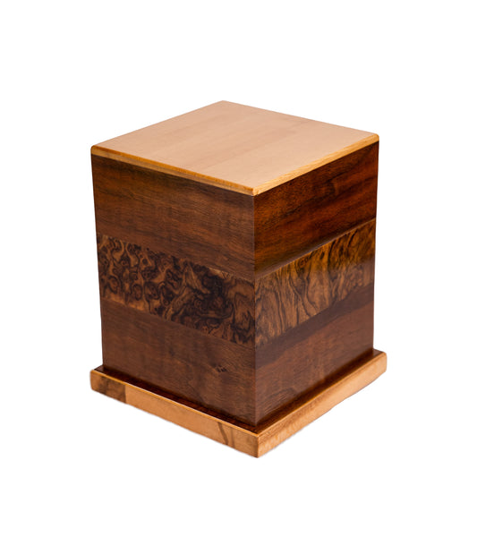 Handcrafted cremation urn with English Walnut Burl band from 1885 German piano, American Black Walnut body, and European Spruce top, 115 cubic inch capacity, angled view