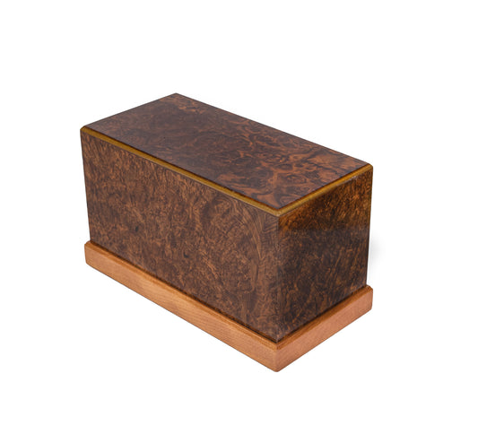 Angled view of handcrafted urn, 150 cubic inch, English Walnut Burl from 1910 German piano with Red Oak and Cuban Mahogany base, glossy finish