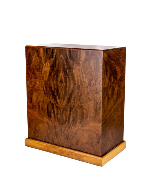Handcrafted cremation urn with book-matched English Walnut sides, Honduran Rosewood top, and Red Oak base, made from 200-year-old woods reclaimed from an 1896 piano, 220 cubic inch capacity, angled view