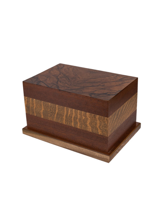 Angled view of 185 cubic inch urn made from 1923 English Oak, 1890 Walnut Burl, and Black Walnut panels, honoring heritage with natural elegance