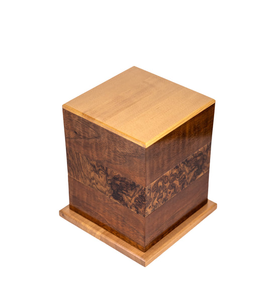 Angled view of 110 cubic inch urn with Black Walnut body, English Walnut Burl band from 1885 German piano, and European Spruce top