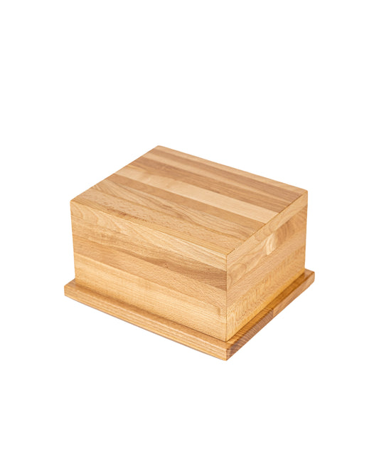 Angled view of 70 cubic inch keepsake urn made from 1901 Hard Rock Maple piano pinblock, high gloss finish, natural grain left unstained