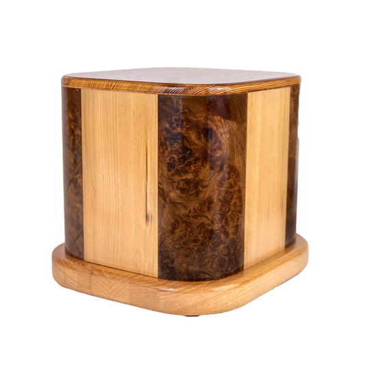 Handcrafted cremation urn made from English Walnut Burl, Ash, Mahogany, and Oak, built from four vintage pianos, 200 cubic inch capacity, angled view