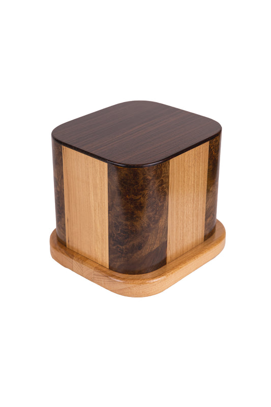 Handcrafted cremation urn made from four vintage piano woods including English Walnut Burl, American White Ash, Macassar Ebony, and Oak, 200 cubic inch capacity, angled view